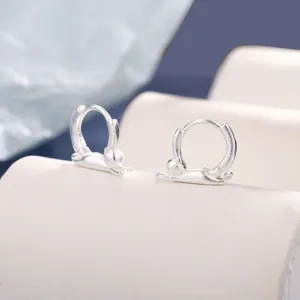 Close-up of matte silver cat hoop earrings with creative stretching cat design details