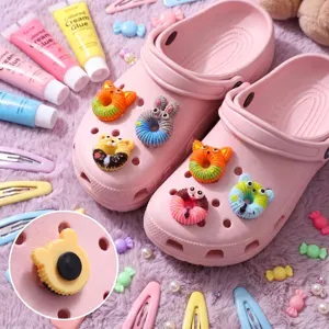 Detailed macro view of cute animal donut shoe charms and their back attachment buttons