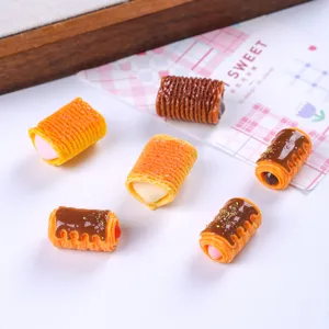 Detailed macro view of miniature resin egg roll cookies for creative DIY craft projects.