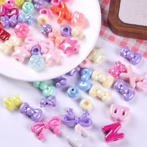 Close-up macro view of colorful AB coated acrylic beads in various shapes for DIY jewelry making