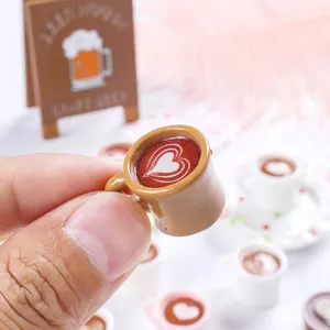 Macro detail of a miniature resin coffee cup featuring heart latte art for dollhouse decor