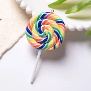 Macro view of a colorful rainbow spiral polymer clay lollipop pendant with metal loop.