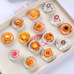 Detailed variety of miniature resin dessert fridge magnets displayed on a cream tray