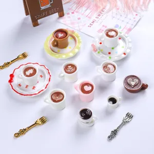 Detailed view of miniature resin coffee cups and saucers with latte art for dollhouse decor