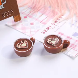 Close-up of miniature resin coffee cups with heart latte art pattern design