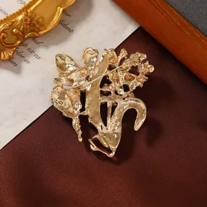 Detailed macro view showing the sturdy golden pin back and structural design of the fairy brooch