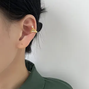 Vista dettagliata di un earcuff a corona a V placcato oro con zirconi scintillanti