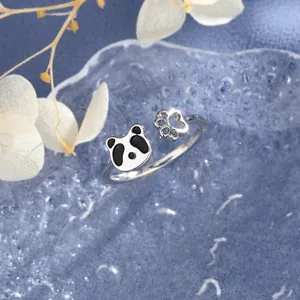 Macro view of a cute cartoon panda and paw print adjustable silver-tone open ring