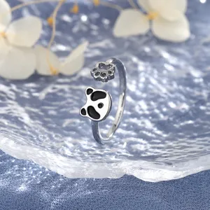 Close-up detail of silver panda ring with paw print and black enamel accents for women