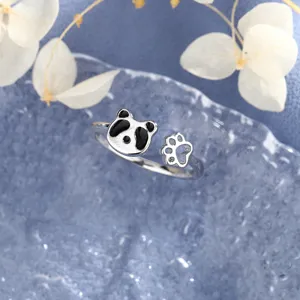 Close-up detail of a cute silver panda open ring featuring a hollowed paw print design