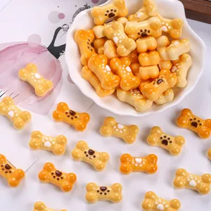 Close-up of cute resin bone biscuit charms with paw prints for DIY hair clips and crafts.