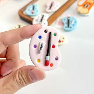 Close-up detail of miniature pink resin paint palette accessory for DIY jewelry and charms