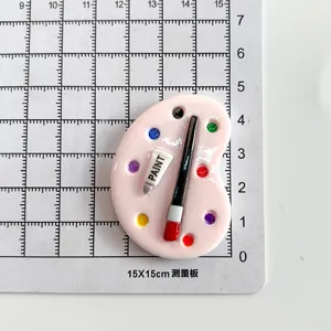 Close-up of a miniature pink palette resin accessory on a measuring grid board