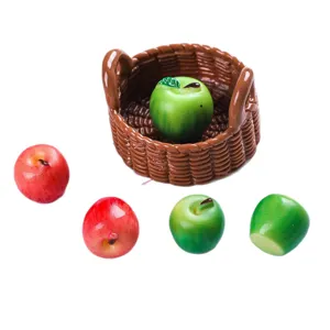 Detailed view of miniature resin red and green apples with a tiny brown basket