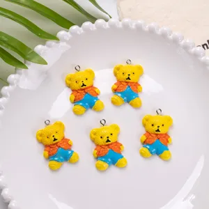 Close-up of five cute resin teddy bear charms for DIY phone cases and jewelry accessories