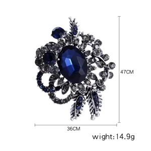Detailed view of vintage dark blue rhinestone flower brooch with 47cm and 36cm size markers
