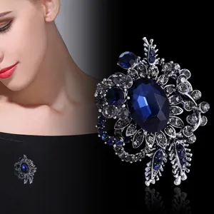 Close-up of vintage medieval style blue crystal flower brooch with silver base