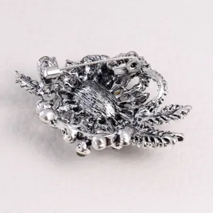 Detailed view of vintage silver-toned floral brooch back with secure pin mechanism