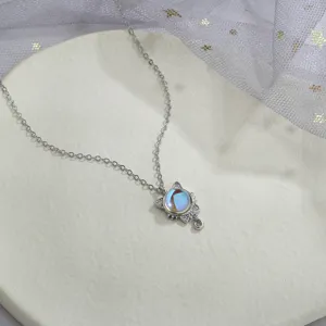 Detailed view of a colorful moonstone cat pendant necklace with sparkly rhinestone ears