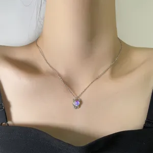 Detail shot of a cute colorful moonstone cat pendant on a silver clavicle chain