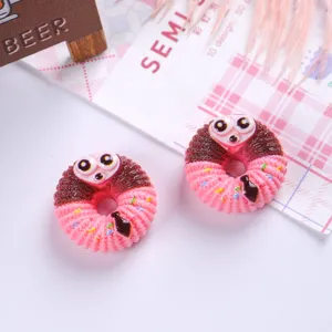 Detailed view of miniature pink and brown cartoon animal donut resin charms for DIY crafts