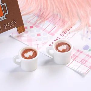 Close-up of miniature resin coffee cups with heart-shaped latte art