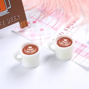 Miniature white resin coffee cup dollhouse accessory with heart latte art detail