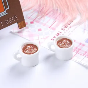 Detailed close-up of miniature resin coffee cups featuring exquisite heart latte art