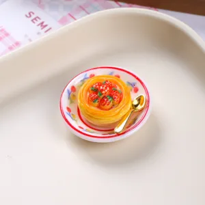 Detailed view of miniature resin strawberry tart on a plate with golden spoon accessory