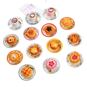 Detailed view of miniature resin dessert collection including tarts and coffee cups