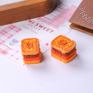 Detailed view of two miniature resin sandwich bread figurines for DIY dollhouse crafts.