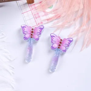 Detailed close-up view showing two purple glittery butterfly resin magic wand DIY charms