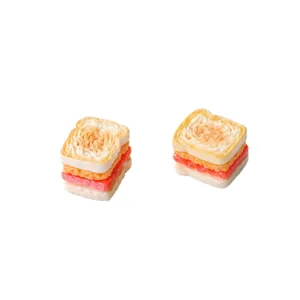 Close-up of two miniature resin toast sandwich charms for dollhouse DIY projects