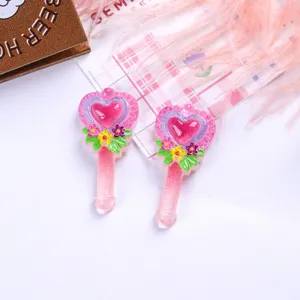 Detail view of pink glitter heart magic wand resin charms for DIY craft accessories