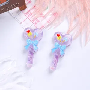 Detailed macro shot of purple glitter heart magic wand resin charms for DIY crafts