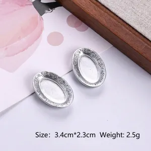 Detail view of miniature silver oval trays with floral patterns for dollhouse DIY crafts