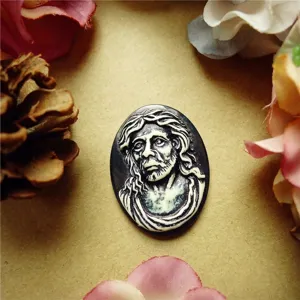 Detailed macro shot of a vintage resin relief cameo featuring a bearded man face