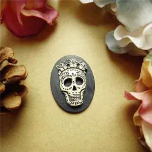 Macro view of resin skull relief jewelry accessory with rose accents for DIY crafts