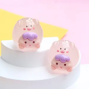 Detailed view of translucent pink jelly-colored cartoon pig resin charms for DIY jewelry