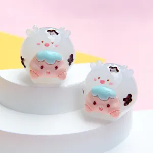 Two cute luminous jelly-textured cartoon sheep animal figurines on a white display stand