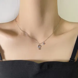 Close-up of the delicate moonstone cat pendant necklace worn by a female model.