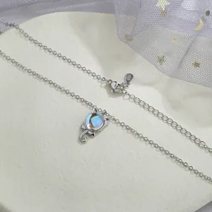 Close-up view of the cute iridescent moonstone cat pendant on a S925 silver necklace