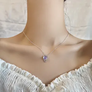 Detailed close-up of a kitten pendant with purple iridescent moonstone on a silver chain