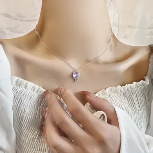 Dainty silver cat pendant necklace featuring a glowing purple moonstone for women