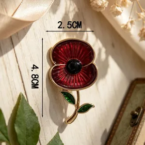 Macro view of an elegant red poppy enamel brooch with green leaf detail and dimensions.