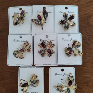 Close-up of vintage alloy brooches with multi-color crystals on display cards