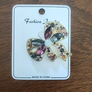 Detailed macro shot of a vintage alloy bow brooch with colorful sparkling rhinestones