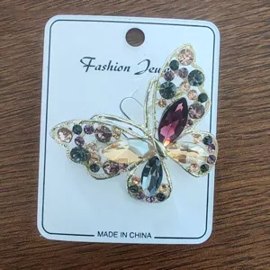 Detailed view of a vintage alloy butterfly brooch adorned with multi-colored rhinestones