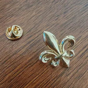 Close-up of a premium golden Fleur-de-lis lapel pin with clutch back for men