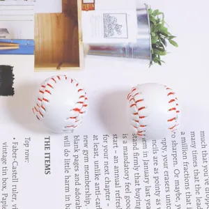 Detailed close-up of two mini baseball accessory pendants with realistic red stitching